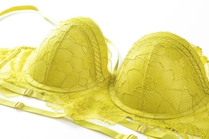 Close-up of lemon yellow lace bra featuring floral embroidery and eyelash trim detail