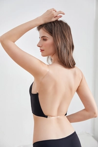 Detail of seamless backless bra set with invisible transparent straps on black fabric