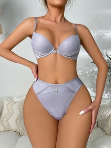 Detailed macro view of lavender lace push-up bra set featuring metallic buckle accents