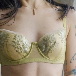 Elegant olive green lace bra with yellow floral embroidery and sheer mesh details