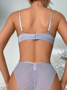 Detail of lavender mesh bra set with thin straps, back buckle, and sheer high-waist panty