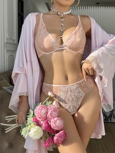 Detailed view of women's three-piece pink lace lingerie set with silk-textured bathrobe