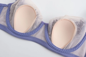 Detail of lavender mesh bra with delicate rabbit ear lace embroidery and inner padding