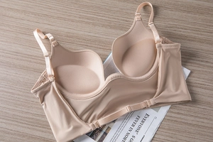 Detailed view of seamless beige bra interior featuring molded cups and adjustable straps