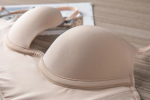 Detailed macro view of beige seamless U-shape bra with smooth fabric and neat stitching