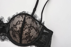 Close-up of black floral eyelash lace bra featuring delicate embroidery and bow detail