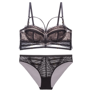 Elegant black lace lingerie set with floral patterns and strappy details on white background