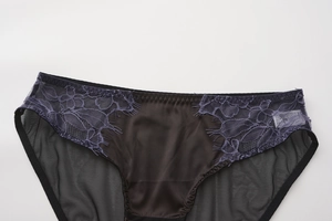 Detailed close-up of women's black satin underwear with delicate purple eyelash lace trim