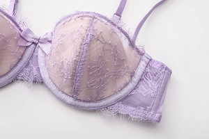 Detail of lavender French eyelash lace bra with floral patterns and a ribbon bow