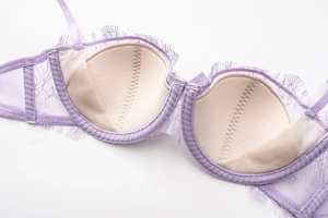 Detail of lavender lace bra showing inner cup lining and delicate mesh side wings
