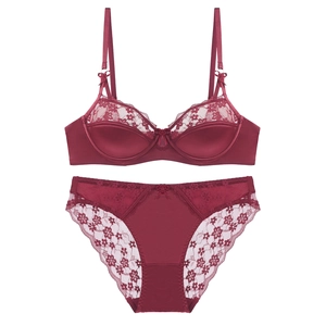 Lace patchwork satin lingerie set in deep red with bow detail on white background