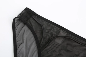 Macro shot of black sheer mesh fabric with fine hexagonal weave and smooth seams