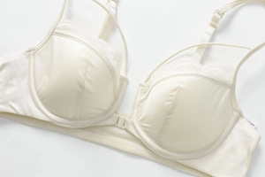 Front-closure off-white lace bra with smooth satin cups and breathable mesh detail