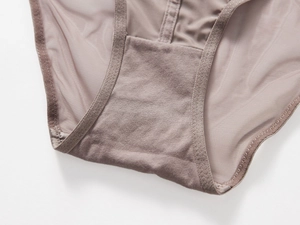 Detail view of cotton crotch lining and sheer mesh fabric on mocha low-waist panties