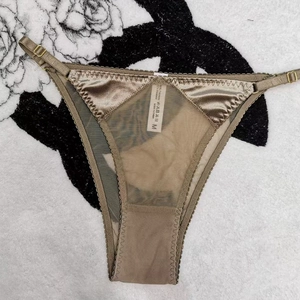 Dettaglio della mutandina in raso bronzo e mesh con fibbie metalliche dorate