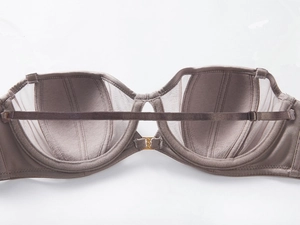 Detailed close-up of seamless dusty pink bra with sheer mesh and smooth fabric
