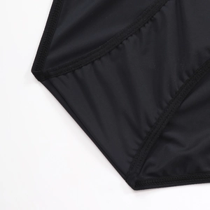 Detailed close-up of smooth black fabric with professional stitching and elastic edges