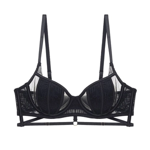 Close-up of black floral lace bra with metal ring detail and crisscross straps decoration