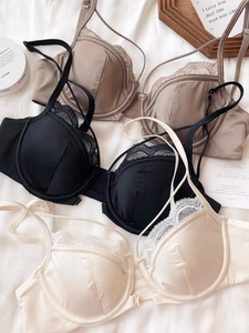 Detailed flat lay of French style silk bras with lace trim and adjustable thin straps
