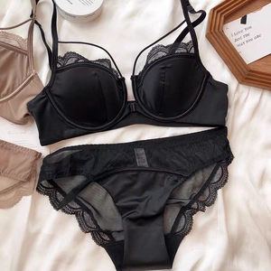 Flat lay of black lace lingerie set featuring thin straps and scalloped eyelash lace details
