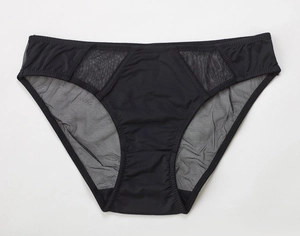 Detail view of black mid-waist seamless panties with breathable mesh paneling and soft fabric