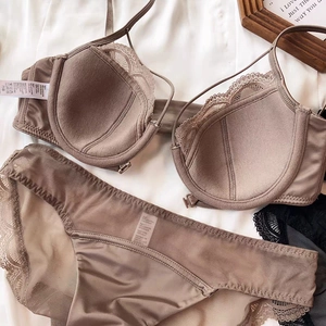 Detailed flat lay of a lace-trimmed taupe lingerie set with size 75B label shown