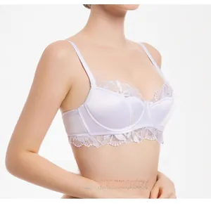 Detail of white satin bra featuring delicate lace trim and supportive wide straps