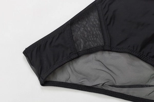Detail of black seamless bra featuring breathable diamond mesh and reinforced elastic edges