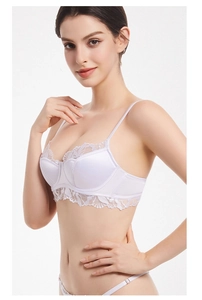 Detail of white satin cup and delicate lace underband on a wired supportive bra