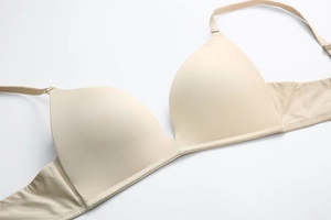 Detail of seamless nude wireless bra showing smooth molded cups and thin straps