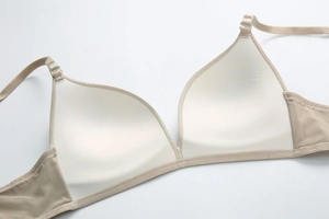 Close-up of seamless beige bra interior showing smooth fabric texture and fine stitching