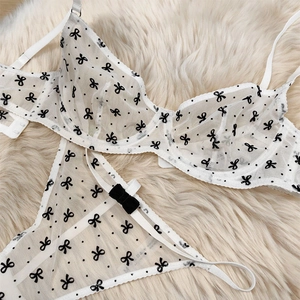Détails de lingerie en maille blanche avec motifs de nœuds noirs et velours