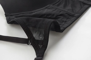 Detailed close-up of breathable black mesh fabric and precise stitching on the bra
