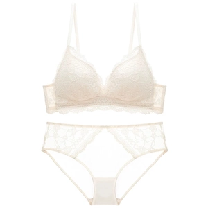 Flat lay of off-white lace lingerie set with floral patterns and transparent mesh details