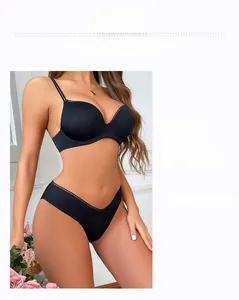Detail of black seamless push-up bra set with lace trim and gold charm decoration