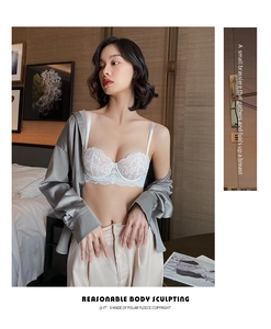Detail showing white lace bra with semi-cup floral pattern and premium texture