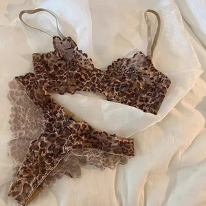 Close-up of leopard print lace lingerie set with elegant scalloped edges on silk background