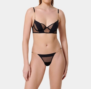 Detail of sheer black mesh lingerie set with geometric lines and gold metal hardware
