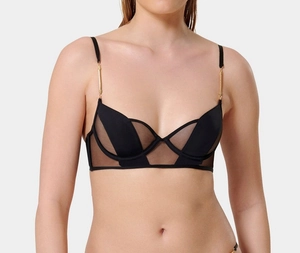 Detail of sheer black mesh bra featuring gold metal buckles and supportive underwire