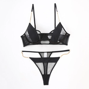 Sexy black mesh lingerie set with golden chain straps and matching thong on white background