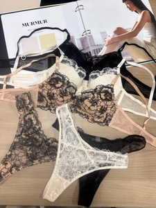 Detailed flat lay of French lace lingerie set with floral embroidery and mesh texture