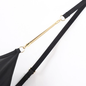 Close-up of black mesh bra with gold metal chain link and delicate strap detail