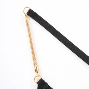 Close-up of golden metal snake chain with lobster clasp and black elastic lace fabric