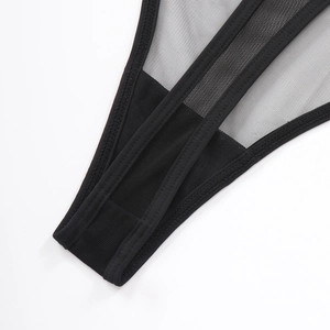 Close-up of black mesh lingerie set showing detailed stitching and sheer fabric texture