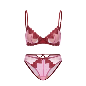 Detailed embroidery on a dark red French lace bra with polka dot mesh and bow detail