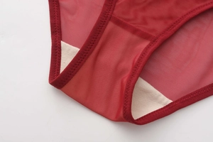 Detail of red mesh underwear showing breathable fabric and soft cotton crotch lining