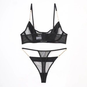 Sexy black sheer mesh lingerie set with golden chain straps and thong on white background