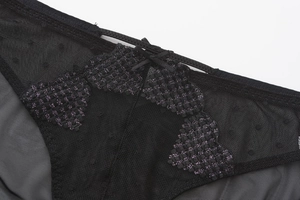Close-up of black sheer mesh panties with purple metallic butterfly embroidery and bow detail