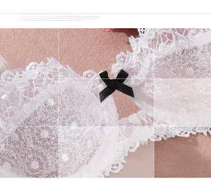 Close-up of white floral lace bra detail featuring a delicate black satin ribbon bow