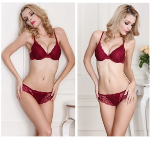 Close-up detail of dark red lace lingerie set with push-up bra and floral patterns
